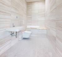 A bathroom with tiles and a sink in a family house, minimalist design.