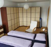 A bedroom in a 3-room apartment with a large corner wardrobe and an armchair.