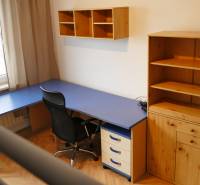 Home office with a blue desk and wooden storage furniture in a 3-room apartment.