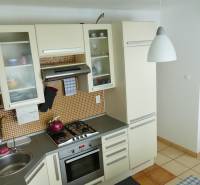 A kitchen in a 3-room apartment with a corner sink and a gas stove.