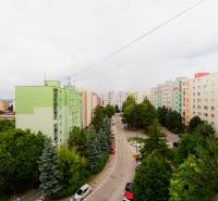A view of the housing estate in Trenčín on Halalovka Street, surrounded by greenery and apartment buildings.
