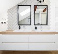A bathroom in a 4-room apartment with two sinks, mirrors, and a white radiator.