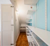Wardrobe in a 4-room apartment with shelves and a closet, wooden floor.