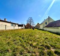Building plots in Moravské Lieskové for house construction, grassy area between buildings.