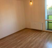 A room with a light floor, a radiator, and balcony doors in a 3-room apartment.