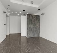 White walls and glossy tiles in commercial spaces, minimalist style and lighting.