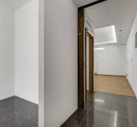Interior of commercial spaces with white walls and combined flooring.