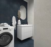 A bathroom with a washing machine, sink, and dark tiles in a 2-room apartment.