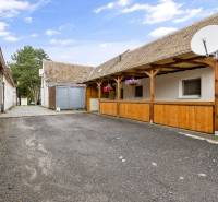 Courtyard space at a 2-room apartment in Malé Leváre with paving and a wooden pergola.