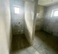 Gray walls of the room with two small windows in a family house.