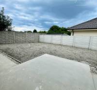 The courtyard of a family house on Čukáraboni in Dunajská Streda with a brick fence and paving.