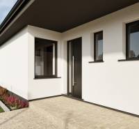 White facade family house on Pánska Niva street, green lawn, and clean sidewalk.