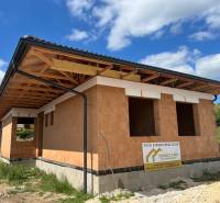 A family house under construction on Pánska Niva in Hlohovec, with a rough brick structure.