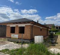 A family house under construction on Pánska Niva in Hlohovec, brick construction, pitched roof.