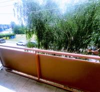 Balcony of a 3-room apartment in Levice with a view of the street and greenery.