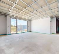 Interior of a family house with an empty room and a large window with a view of the exterior.
