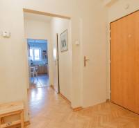 A hallway with an entrance to the kitchen, wooden decor flooring, in a 4-room apartment.