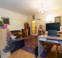 Living room in a four-room apartment with a carpet and a wooden decor floor.