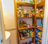 A pantry with shelves full of food in a 4-room apartment.