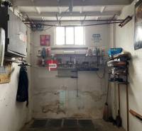 Garages with windows, shelves, and tools, equipment for storage and maintenance.