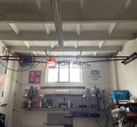 Garage storage space with shelves and tools.