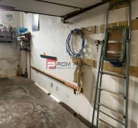 Garage with a shelf, ladders, and tools on the wall in Bratislava III on Pionierska.
