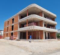 An unfinished building with a 3-bedroom apartment in the town of Vodice on a sunny day.