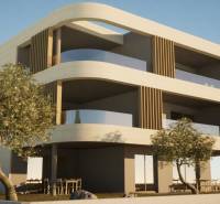 A two-story building with balconies, trees, and outdoor seating near 3-bedroom apartments in Vodice.