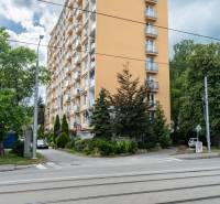 An apartment building on Božena Němcová Street in Košice, Sever district, among the trees.