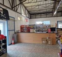 Interior of a space with a high ceiling and shelves, located on Šamorínska Street.