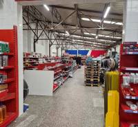 The store on Šamorínska offers various goods among warehouses and halls, with flags hanging.