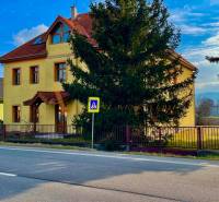 Yellow building on Chrabrany Street in Topoľčany with a sale announcement.