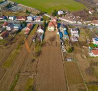 Aerial view of rural houses in Chrabrany near Topoľčany surrounded by fields and gardens.
