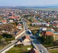 A view of houses and streets in Chrabrany, Topoľčany, under a clear sky.