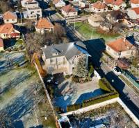 A villa on Športovcov Street in Topoľčany, surrounded by gardens and nearby houses.