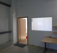 Doors and a table in the interior of warehouses and halls, with a shelf on the wall.