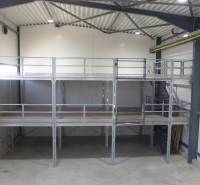 In the warehouse and hall, a shelving system with a steel structure and staircase is visible.
