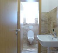 Toilet with a sink, tiled with beige tiles, Warehouses and halls.