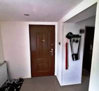 Entrance hallway in a family house with wooden doors, a key holder, and a radiator.