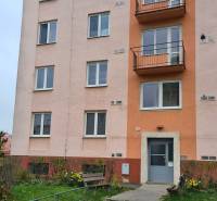 Building on Mudroňova Street, Košice - Juh district, with an entrance and a bench.