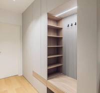 Built-in wardrobe with a bench and shelves in a 3-room apartment.