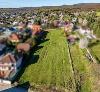 Building plot on Štúrova Street in Marianka, with a view of the surrounding development.