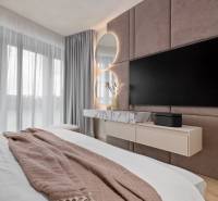 Bedroom in a 3-room apartment with a mirror, TV, and curtains.