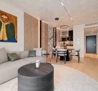 Stylish living space with a sofa, painting, dining table, and wooden floor.