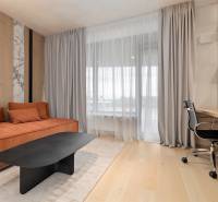 A bright living space in a 3-room apartment with a comfortable sofa and a work corner.