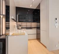 A stylish kitchen in a 3-room apartment with black and white elements, wooden floor.