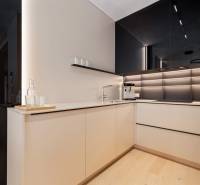 Modern kitchen with black cabinets and white walls in a three-room apartment.