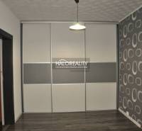 Wall decoration in a 3-room apartment with a sign and cutlery creates a creative atmosphere.