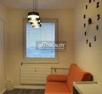 Interior of a 3-room apartment with a wardrobe and geometric wallpaper.