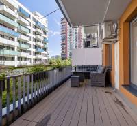 The balcony of a 2-room apartment on Jégého Street in Bratislava - Ružinov with outdoor seating.